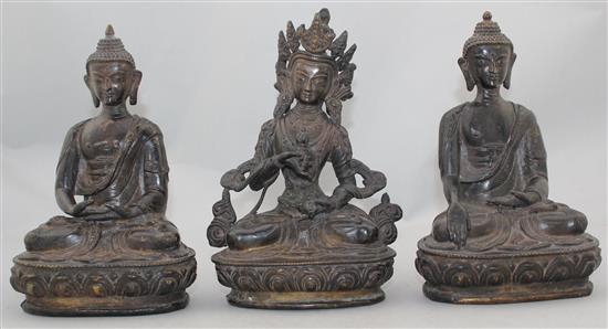 Three A Sino-Tibetan bronze seated figures of Buddhist deities, 20-21cm high